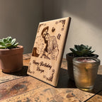Wooden photo frame displayed beside plants